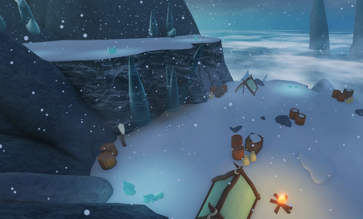 Camp beneath ice crags in falling snow