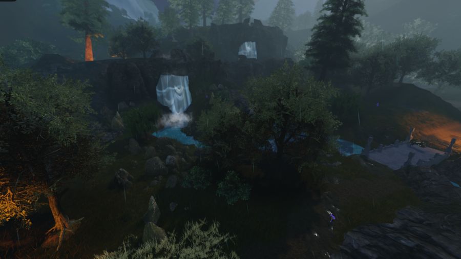 A waterfall and forested valley in the rain